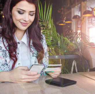 woman using card and phone