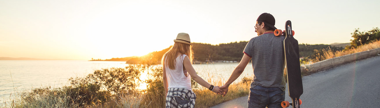 Young couple holding hands at sunset