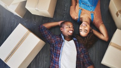 Young couple surrounded by move-in boxes.
