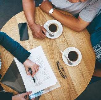 Two people discussing information over coffee