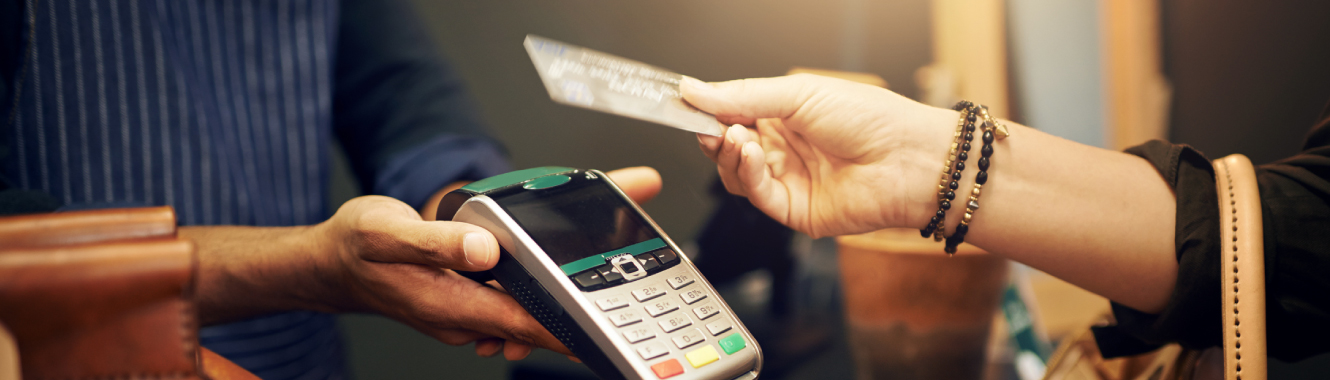 person using their debit or credit card in a store