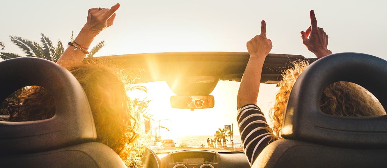 Two happy women on a road trip.