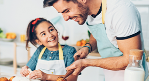 Dad and daughter baking in the kitchen.