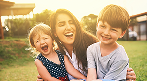 Happy mother and children outdoors.