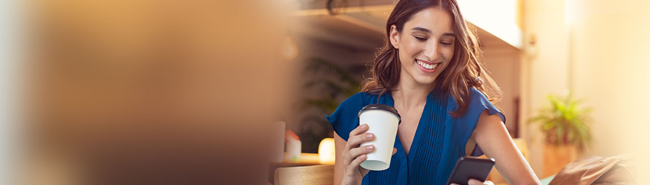 Woman smiling at her mobile phone.